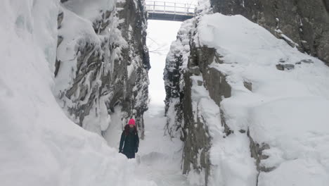 Girl-standing-in-a-big-cave-in-Björkliden,-Sweden