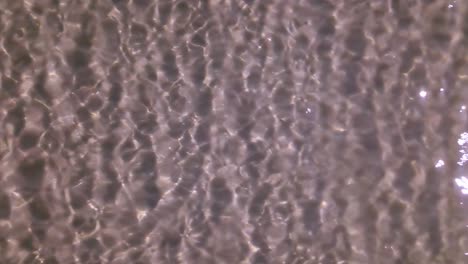 water slowly moving over the sand