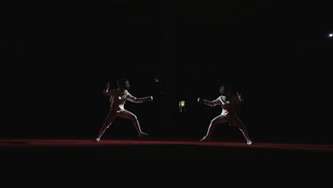 two fencers engage in a competitive match, showcasing their skills and athleticism