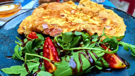 delicious omelette with arugula salad and tomatoes