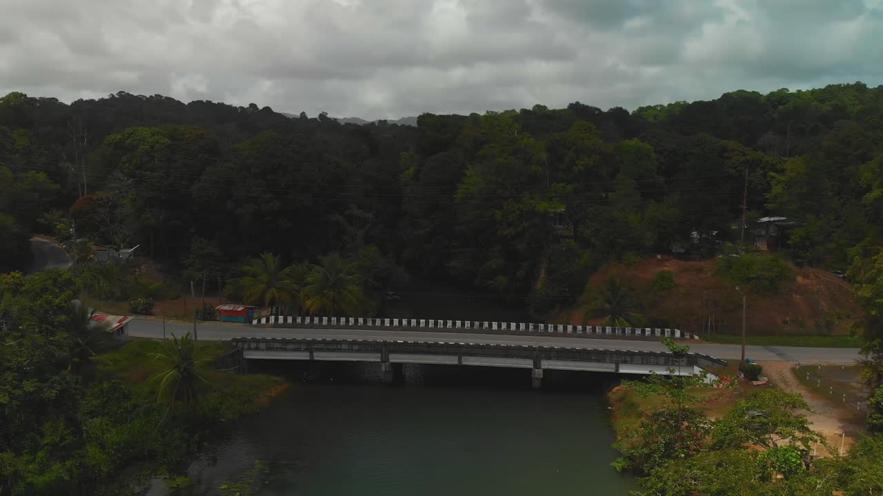 Aerial footage of an ancient bridge at saline bay where the river flows under the bridge and into the sea