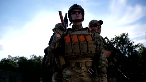 squad of military soldiers in full gear at sunset