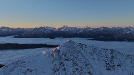 first light bathes the dolomites of val pusteria in a serene sunrise glow