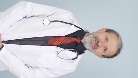 Vertical-video-of-Old-doctor-shows-correct-coughing.