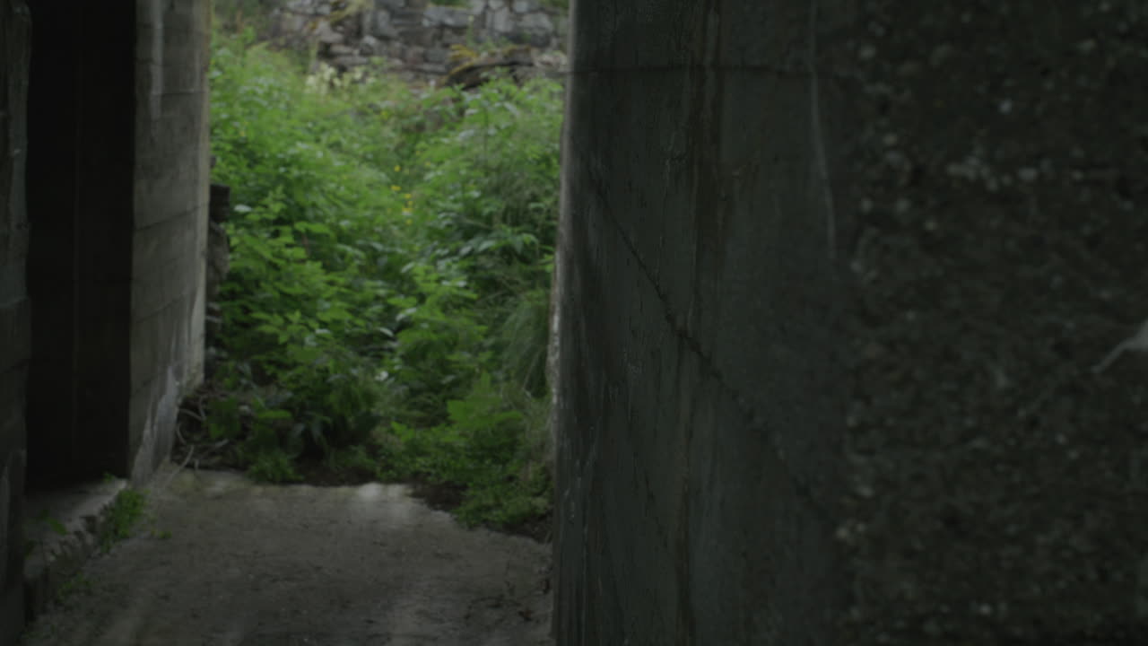 Gimbal shot of bunker wall with focus shift to exit at coastal battery