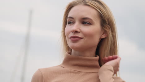 smiling woman looking around outdoors.