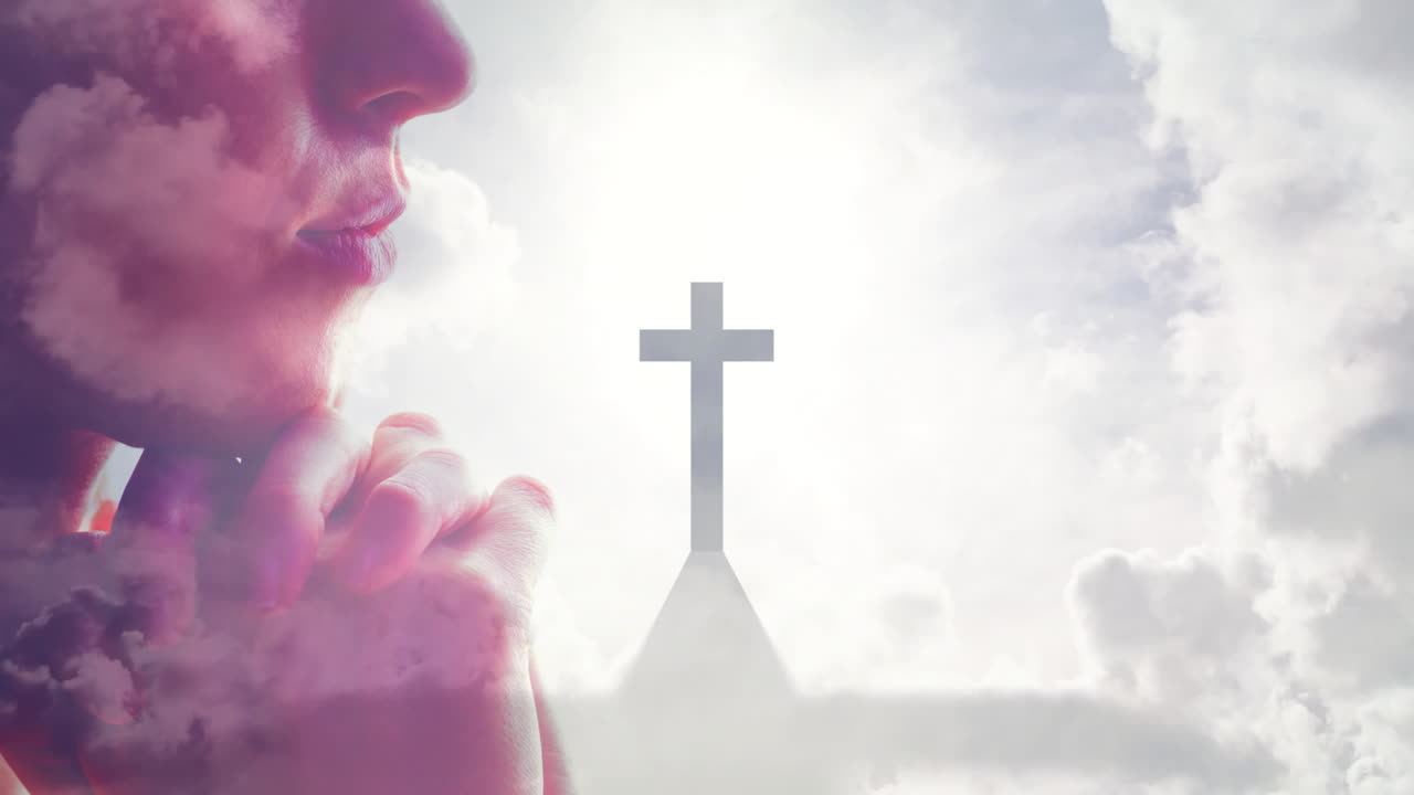 Praying with cross, person in silhouette against cloudy sky background
