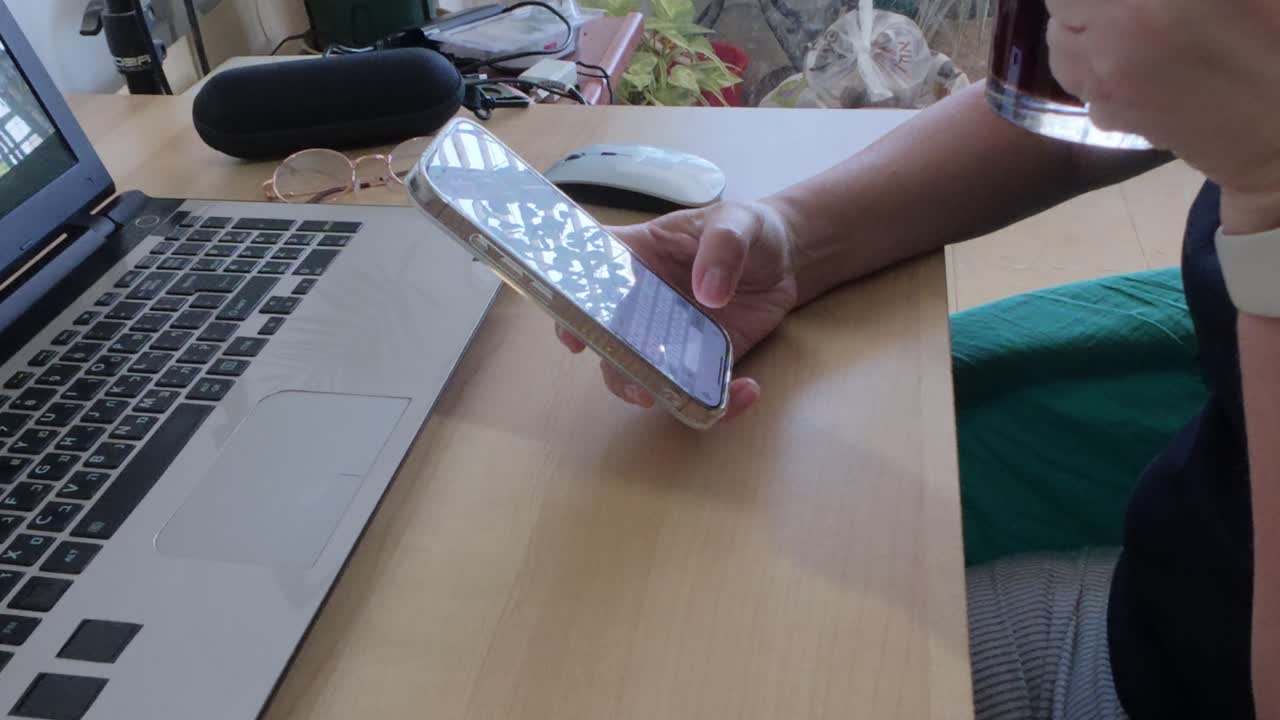 Scene depicting a modern work environment with essential digital tools: smartphone, laptop, coffee