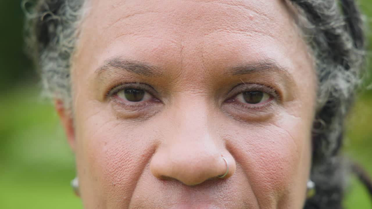 Close-up of senior woman outdoors with eyes closed, feeling peaceful and relaxed