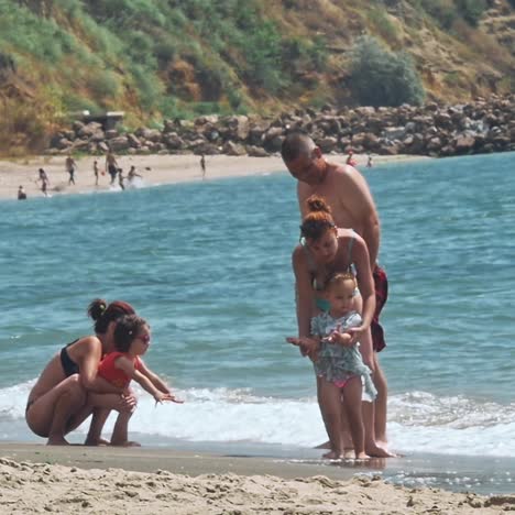 family sunbathing on a sandy tropical beach