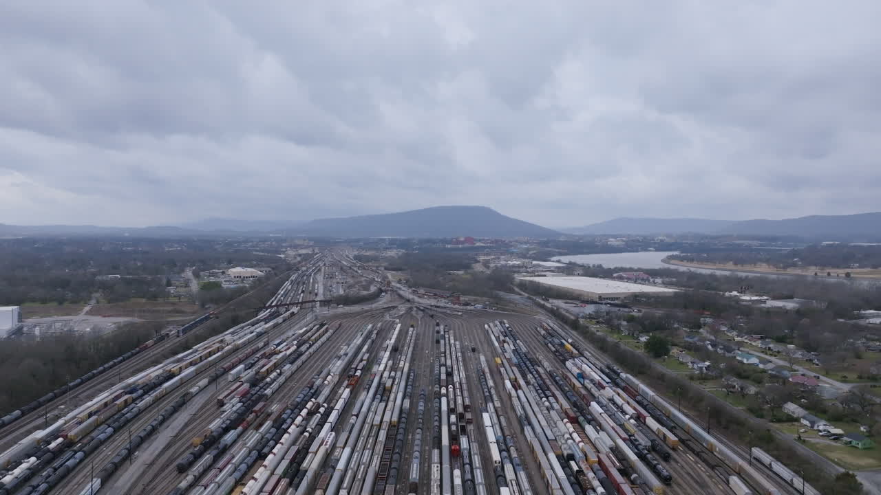 Aerial footage flying over the railyard in Chattanooga, TN with a bunch of train cars lined up getting ready to go.