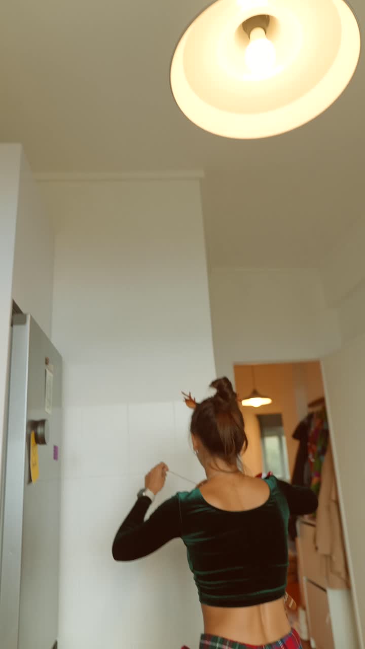 Woman decorating kitchen for Christmas