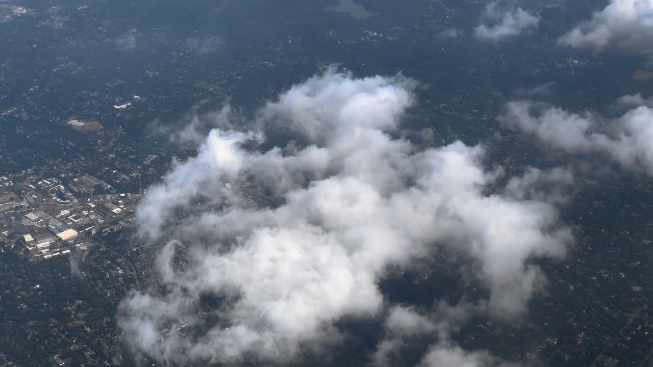 Aerial of clouds under airplane.