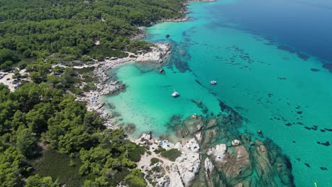 beach kavourotrypes and clear blue sea coastline in halkidiki, greece - aerial 4k