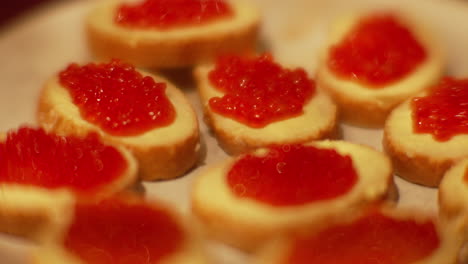 sandwich slices with butter and red roe fish caviar handheld closeup