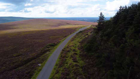 dramatic aerial fly-by over a mountain road in irish mountains