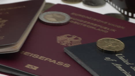 passports and coins are displayed on a white surface