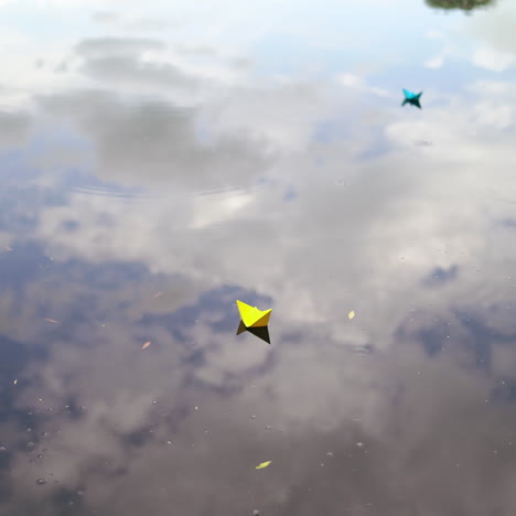 a paper boat sails along the river.