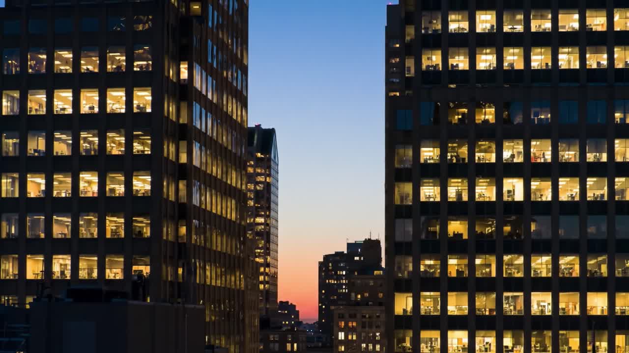 A Stunning Transformation of Urban Skyscrapers from Daylight to Twilight, Showcasing Office Life and Vibrant Cityscape in the Evening Glow