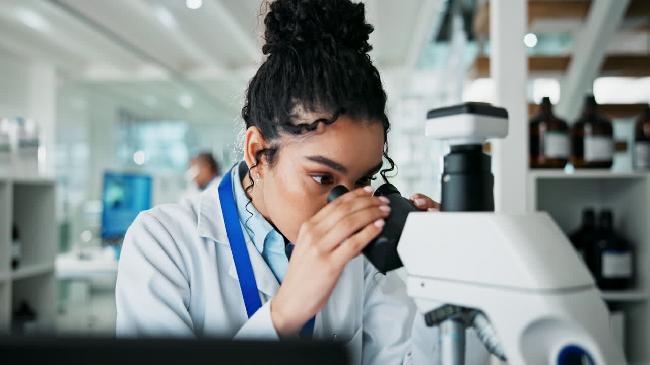 Scientist working in a lab using a microscope