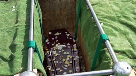 closeup shot of a funeral casket in a hearse or chapel or burial at cemetery