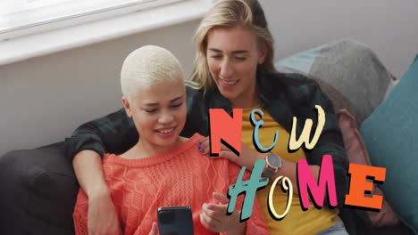 animation of new home text over gay lesbian couple using smartphone at home