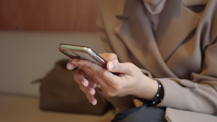 Close Up of Woman's Hands Using a Smartphone