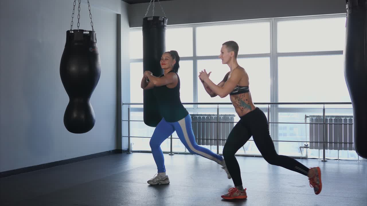 Women working out in a gym with a trainer