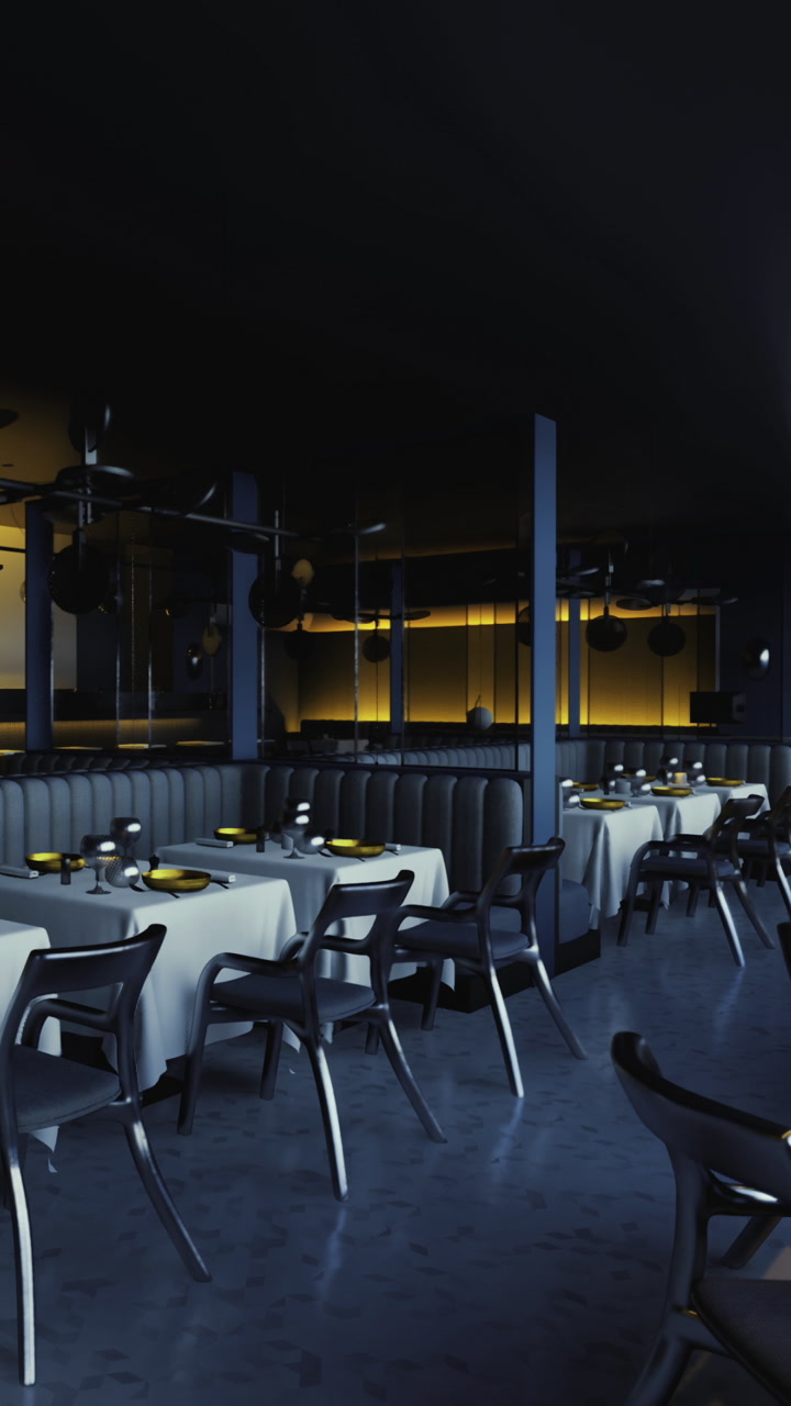 Tables set for dinner in a modern restaurant with low light in the evening