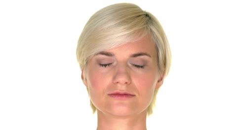 the face of a woman closing her eyes on a perfectly white background