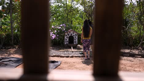 couple enjoys a hike in the countryside and stops to visit the dog's house