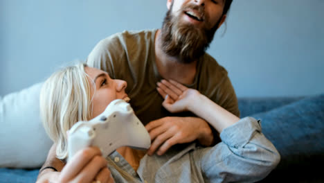 couple playing video games in living room 4k