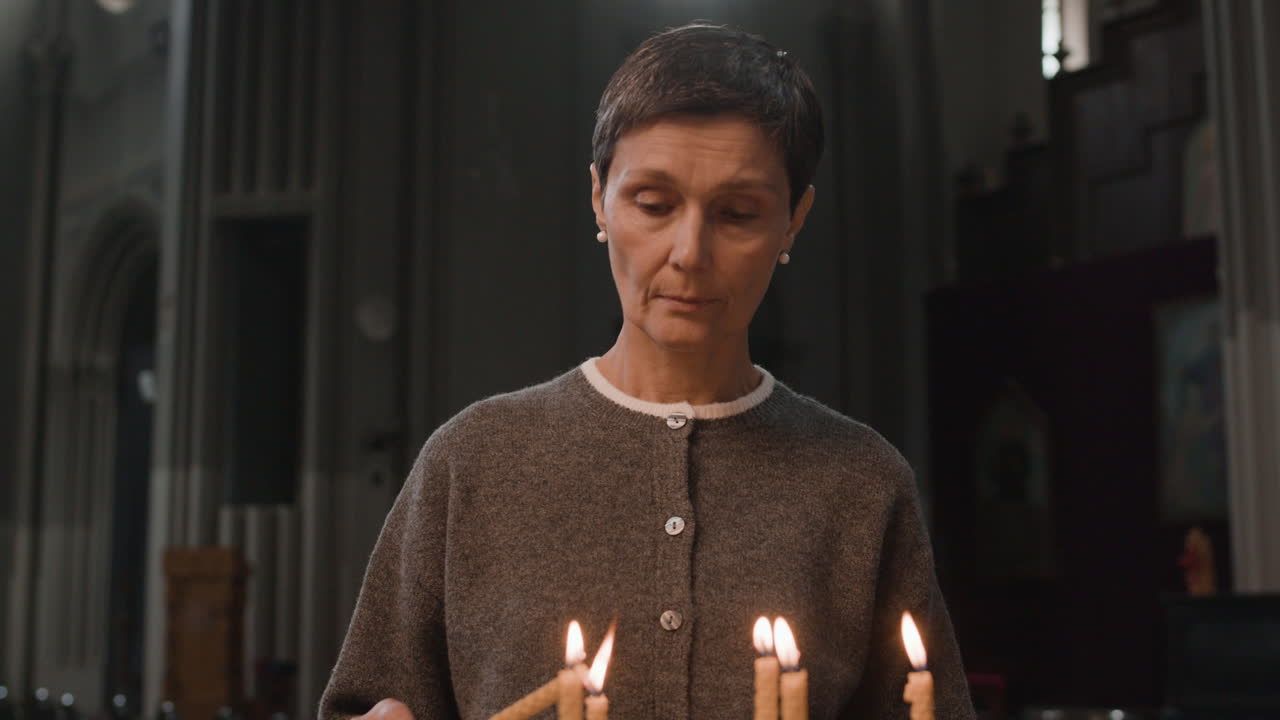 Woman Lighting Candles in Church