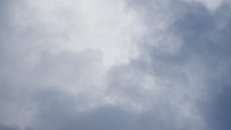 Fluffy-white-clouds-float-across-a-bright-blue-sky