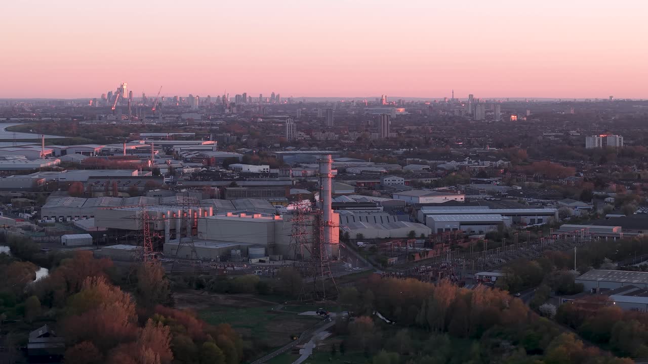 Purple sunset skyline over Enfield power station industrial factory in London aerial view