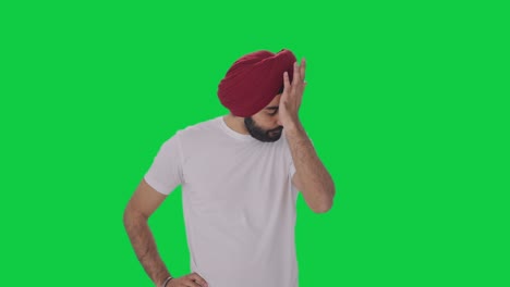 triste y molesto sikh hombre indio pantalla verde