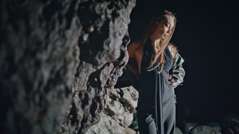 fashion woman dancing night rocks beach closeup. seductive model having party
