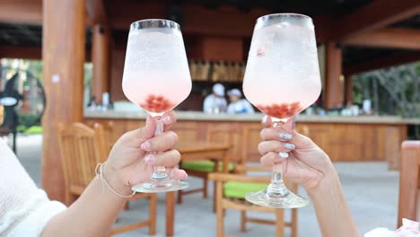 two people clinking glasses in a festive toast