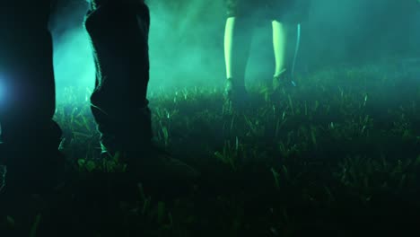 Three-kids-walk-through-foggy-grass-towards-camera