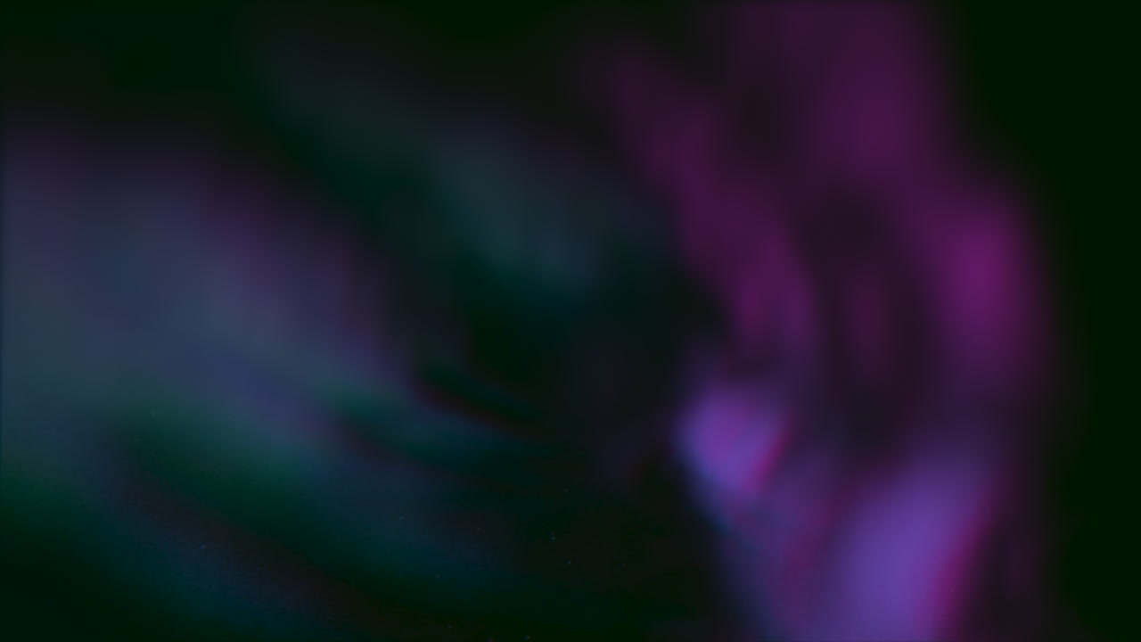 Glowing purple cloud in dark sky