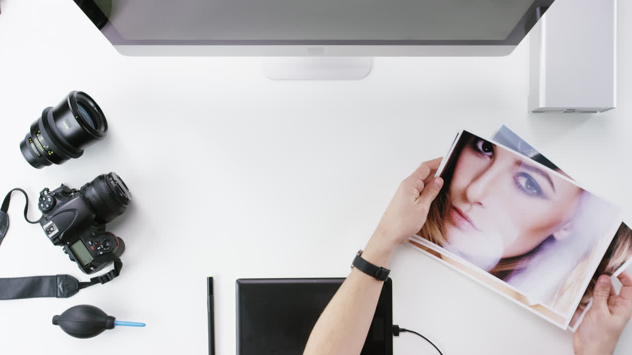 vista superior fotógrafo diseñador gráfico eligiendo imágenes de belleza trabajando en el escritorio desde arriba - dragón épico rojo