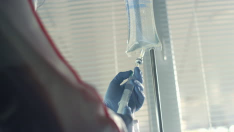 nurse draw solution in clinic ward closeup. healthcare worker preparing therapy