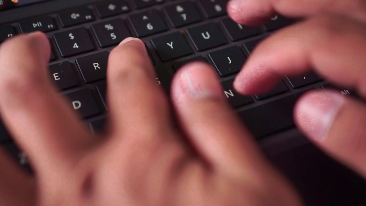 Hand typing on tablet keyboard, mobile device use, remote working, internet communication, closeup view.