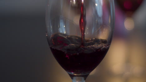 red wine poured into glass in slow motion