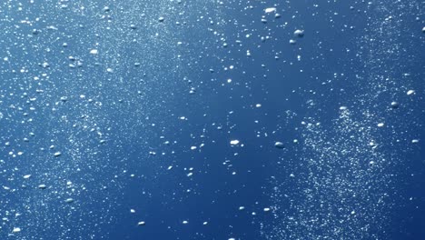 underwater close to surface with the sky view ocean scenery sun beams sun rays and air bubbles slow relaxing ocean backgrounds