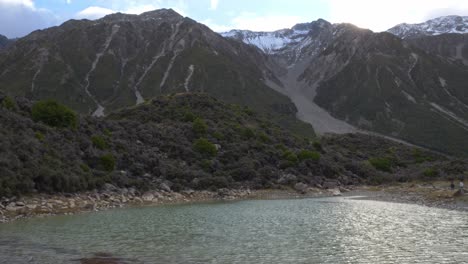 small blue lake - mount cook in south island, new zealand - tilt down shot