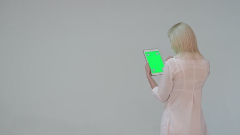 doctor pressing the green screen of a tablet computer