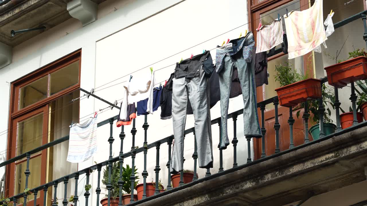 Traditional Porto townhouse with laundry hanging outside, everyday life scene
