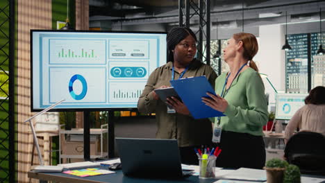 vertical video collaborative team of professional women reviews key data and reports
