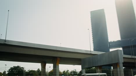 city highway overpass with modern skyscrapers